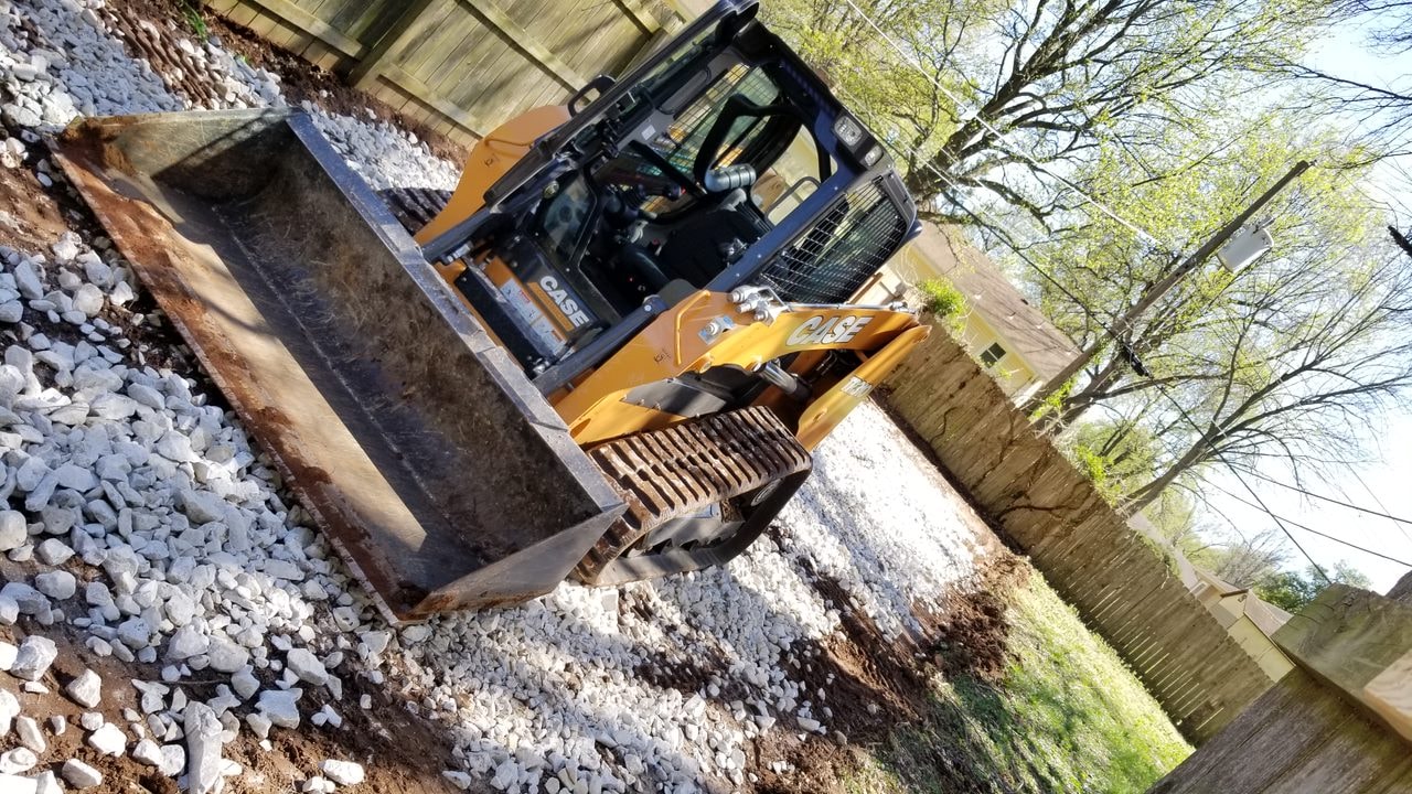 Skid-steer completing residential site preparation